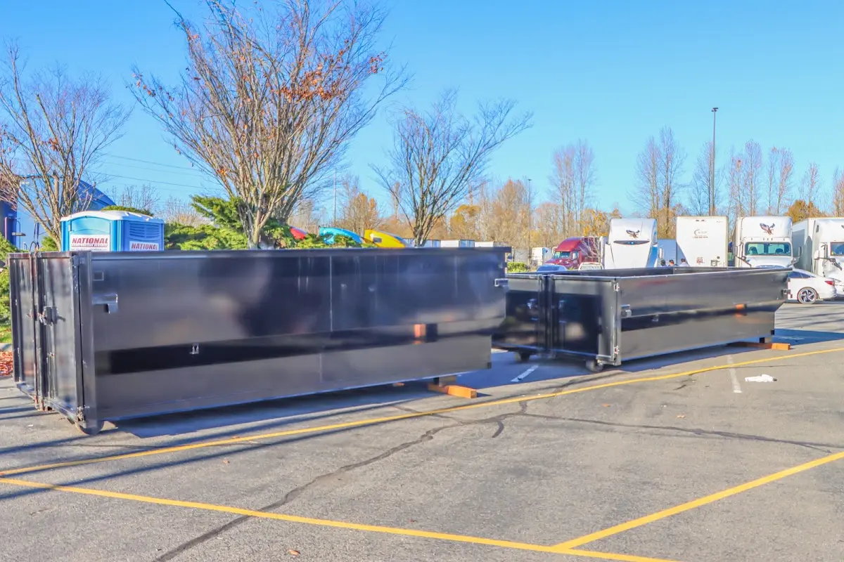 Professional dumpster rental service with roll-off container on residential driveway in Cooper City